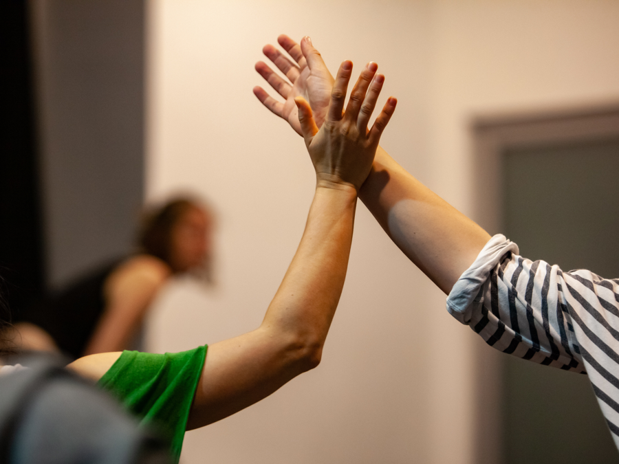 Hands reaching upward — nonverbal communication through movement